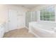 Bright bathroom featuring a large soaking tub and a glass enclosed shower at 3005 Sandbox Cir, Indian Trail, NC 28079