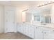 Bathroom with double vanity, large mirror, great lighting, tile floor and white cabinets at 3005 Sandbox Cir, Indian Trail, NC 28079