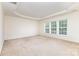 Spacious bedroom with neutral carpet, tray ceiling and bright windows with blinds at 3005 Sandbox Cir, Indian Trail, NC 28079