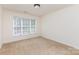 Bedroom with neutral carpet, a large bright window with blinds and ceiling light at 3005 Sandbox Cir, Indian Trail, NC 28079