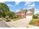 Charming brick two-story home with a spacious driveway, red shutters, and manicured landscaping at 3005 Sandbox Cir, Indian Trail, NC 28079