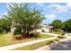 Charming two-story home with manicured lawn, red shutters and a lush tree in the front yard at 3005 Sandbox Cir, Indian Trail, NC 28079