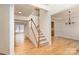 Bright open foyer with hardwood floors, staircase, and access to the dining room and living room at 3005 Sandbox Cir, Indian Trail, NC 28079
