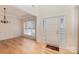 Bright foyer featuring hardwood floors, a white door with sidelights, and access to the dining room at 3005 Sandbox Cir, Indian Trail, NC 28079