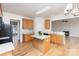 Kitchen featuring wood cabinets, center island, and an open view into the living room at 3005 Sandbox Cir, Indian Trail, NC 28079