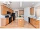 Kitchen with wood cabinets, center island, black appliances, and white countertops at 3005 Sandbox Cir, Indian Trail, NC 28079
