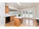 Bright eat-in kitchen area with an island, hardwood floors, and large windows at 3005 Sandbox Cir, Indian Trail, NC 28079