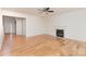 Spacious living room with hardwood floors, a fireplace, and an open doorway at 3005 Sandbox Cir, Indian Trail, NC 28079