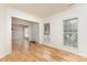 Bright living room with hardwood floors, large windows, and an open layout next to the foyer at 3005 Sandbox Cir, Indian Trail, NC 28079