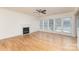 Spacious living room featuring hardwood floors, a fireplace, and an abundance of natural light from large windows at 3005 Sandbox Cir, Indian Trail, NC 28079