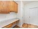 Mudroom with wooden cabinets, a marble countertop, built-in desk, and hardwood floors at 3005 Sandbox Cir, Indian Trail, NC 28079