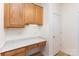 Mudroom with wooden cabinets, a marble countertop, built-in desk, and white doors at 3005 Sandbox Cir, Indian Trail, NC 28079
