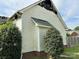 Side view of a fire-damaged one-story home with white siding and brick foundation at 3205 Creek Trail Rd, Indian Trail, NC 28079