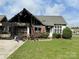Fire-damaged one-story home with partial roof loss, driveway, and green lawn at 3205 Creek Trail Rd, Indian Trail, NC 28079