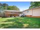 Spacious backyard featuring a two-story home with deck, covered area, and lush lawn perfect for outdoor activities at 3265 W Innes St, Salisbury, NC 28144
