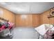 Clean unfinished basement space with painted floors and wood paneling on the walls, with room for personalization at 3265 W Innes St, Salisbury, NC 28144