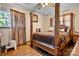 Bedroom with four-poster bed and hardwood floors at 3265 W Innes St, Salisbury, NC 28144