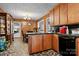 Vintage kitchen with wood cabinetry and black appliances, offering a functional space with an adjacent dining area at 3265 W Innes St, Salisbury, NC 28144