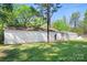 Outdoor storage shed in backyard, surrounded by a lush green lawn and mature trees on a sunny day at 3265 W Innes St, Salisbury, NC 28144