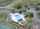 Aerial view of community pool, clubhouse, tennis courts, and green spaces, offering recreational amenities and community features at 4027 Wallbrook Dr, Matthews, NC 28105
