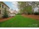Spacious backyard with lush lawn, mature trees, providing a serene and private outdoor space at 4027 Wallbrook Dr, Matthews, NC 28105