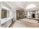 Bright bathroom featuring a large soaking tub, walk-in shower, tile floor, and neutral countertops and cabinetry at 4027 Wallbrook Dr, Matthews, NC 28105