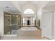 Bright bathroom featuring a large soaking tub, walk-in shower, tile floor, and neutral countertops at 4027 Wallbrook Dr, Matthews, NC 28105