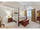 Bedroom features a four-poster bed, a window with floral curtains, and bedside tables with lamps at 4027 Wallbrook Dr, Matthews, NC 28105