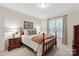 Cozy bedroom with a four-poster bed, bedside tables with lamps, and a window with curtains at 4027 Wallbrook Dr, Matthews, NC 28105