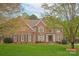 Charming two-story brick home with manicured lawn and inviting front entrance and well maintained landscaping at 4027 Wallbrook Dr, Matthews, NC 28105