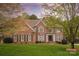 Beautiful brick home with a well-manicured lawn and mature trees in a desirable neighborhood at 4027 Wallbrook Dr, Matthews, NC 28105