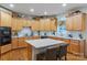 Well-lit kitchen featuring wooden cabinets, stainless steel appliances, an island, and modern finishes at 4027 Wallbrook Dr, Matthews, NC 28105