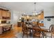 Well-lit kitchen with wooden cabinets, stainless appliances, a dining table with seating, and a built-in desk area at 4027 Wallbrook Dr, Matthews, NC 28105