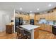 Spacious kitchen featuring wooden cabinets, stainless steel appliances, and a center island with seating at 4027 Wallbrook Dr, Matthews, NC 28105