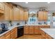 Bright kitchen with wooden cabinets, quartz countertops, modern appliances, and hardwood floors at 4027 Wallbrook Dr, Matthews, NC 28105