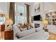 Bright living room with large windows, tall ceilings, a fireplace, built-in shelves, and comfortable seating at 4027 Wallbrook Dr, Matthews, NC 28105