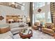 Open concept living room with vaulted ceilings, large windows, comfortable seating, and a view of the kitchen and dining area at 4027 Wallbrook Dr, Matthews, NC 28105