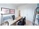 Well-lit home office with a wooden desk, chair, and decorative shelving at 4372 Bronze Blvd, Sherrills Ford, NC 28673