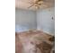 An empty bedroom with dated ceiling fan and blue painted walls at 4406 Valeview Ln, Charlotte, NC 28269