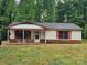 Single story home with a covered front porch and brick base sitting on a large lot at 4406 Valeview Ln, Charlotte, NC 28269
