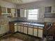 Outdated kitchen featuring white cabinets, laminate countertops, and double basin sink at 4406 Valeview Ln, Charlotte, NC 28269