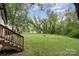 Backyard featuring stairs down to a spacious grassy lawn at 500 3Rd St, Stanley, NC 28164