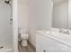 Bathroom featuring a walk-in shower, gray laminate flooring, toilet and white sink vanity at 500 3Rd St, Stanley, NC 28164