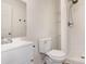Bathroom showcasing a walk-in shower, toilet, shelving, and a white sink vanity at 500 3Rd St, Stanley, NC 28164