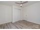 Bedroom showcasing a ceiling fan, laminate flooring and a closet at 500 3Rd St, Stanley, NC 28164