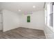 Bright bedroom featuring modern floors, a window, and a closet at 500 3Rd St, Stanley, NC 28164