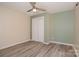 Bedroom showcasing a closet, laminate flooring, modern paint, and ceiling fan at 500 3Rd St, Stanley, NC 28164