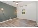 Bedroom showcasing a ceiling fan, laminate flooring, and decorative lighting at 500 3Rd St, Stanley, NC 28164