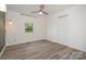 Bedroom featuring a ceiling fan, laminate flooring, window and sconce lighting at 500 3Rd St, Stanley, NC 28164