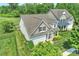 Birds-eye view showcasing a suburban home with a manicured yard and a backdrop of lush trees at 505 Chamberlain Ct, Mcadenville, NC 28101